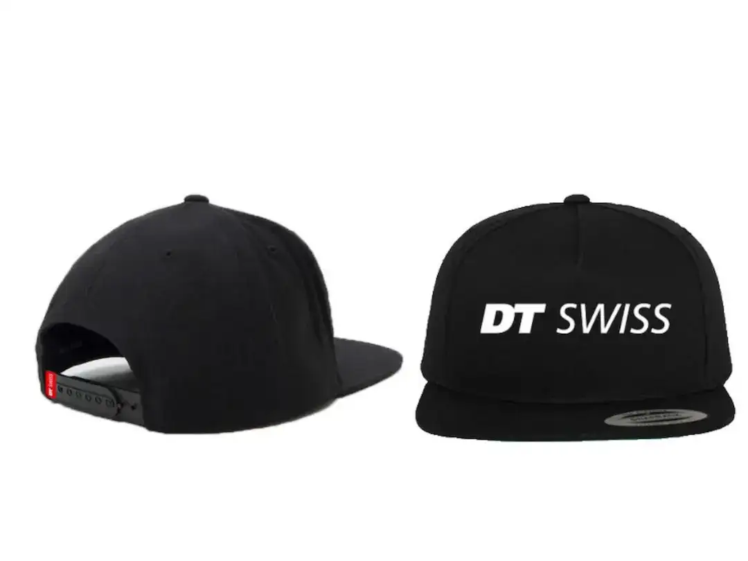 Two black snapback caps, one showing the back with red adjustable strap and the other front-facing with a white DT SWISS logo on the crown