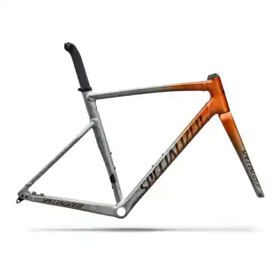 Specialized road bike frame in silver and orange gradient, showing saddle, seatpost, and fork (no wheels).