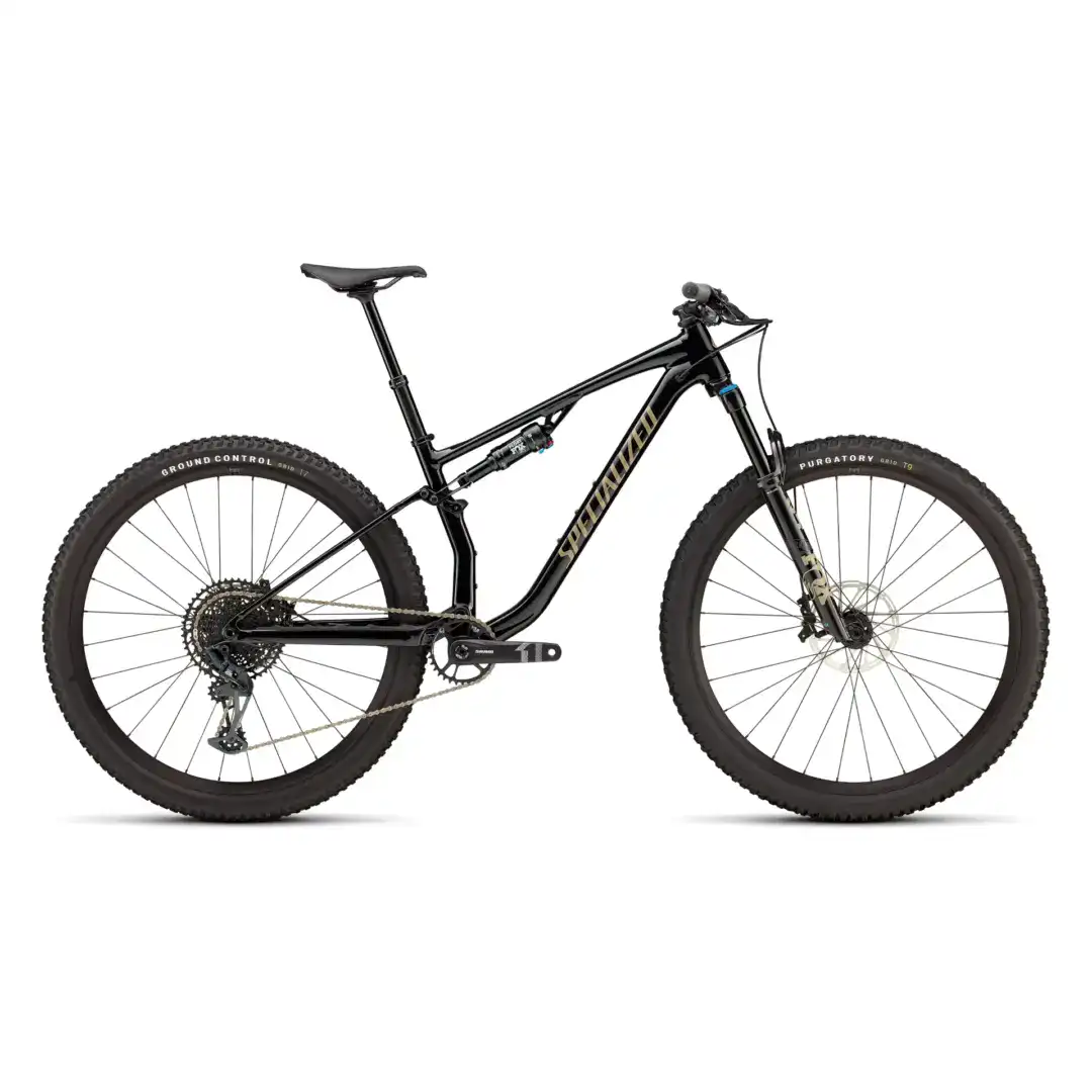 Side view of a black full‑suspension mountain bike with large knobby tires on a white background.