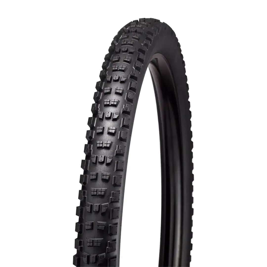 Close-up of a black mountain bike tire with chunky knobby tread for off-road grip