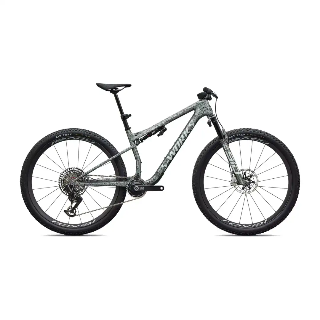 Side view of a camo-gray full-suspension mountain bike with large knobby tires, black saddle, and hydraulic brakes.