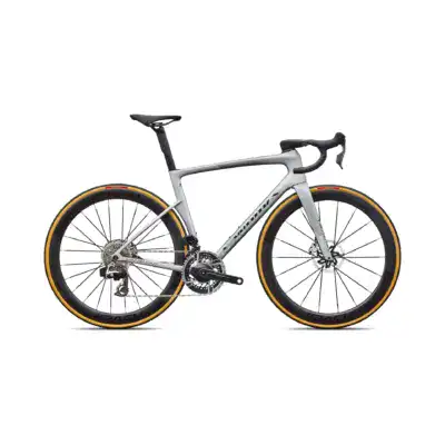 Side view of a gray carbon road bike with drop handlebars and yellow-tinted rims, cropped at the top and bottom edges for a minimal composition.