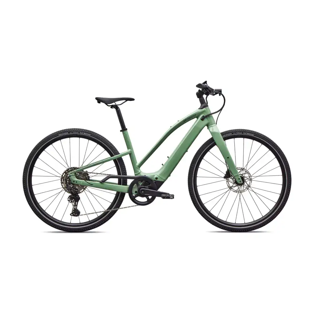 Green mountain bike shown partially, featuring a mid-frame and front handlebars on a white background
