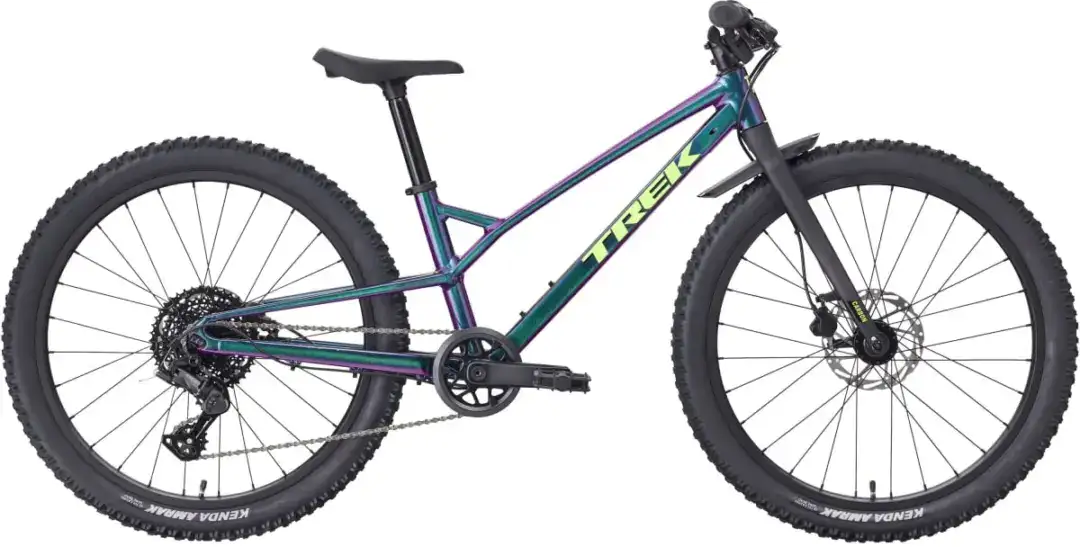 Side view of a Trek mountain bike with an iridescent purple-green frame, front suspension fork, large knobby tires, and disc brakes.