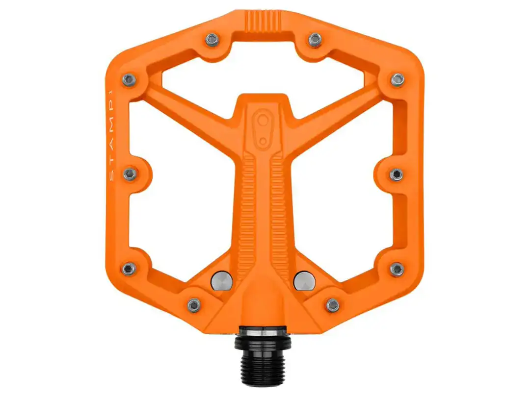 Orange flat bicycle pedal viewed from the bottom, showing a rugged orange plastic body and a black threaded spindle below.