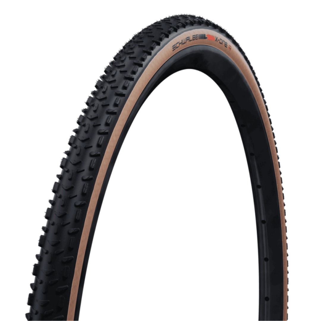 Close-up of a rugged mountain bike tire with large knobby tread and a tan sidewall