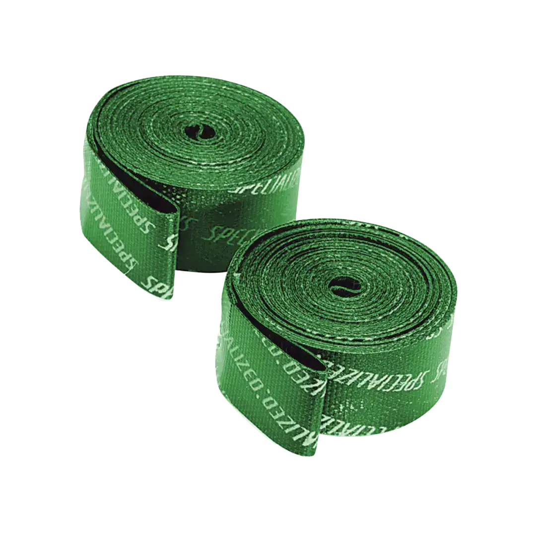 Close-up of green tape rolls coiled into spirals against a black background.