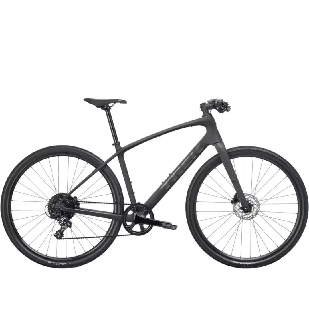 Partial view of a matte black bicycle, showing the frame, crank, derailleur, and wheels.