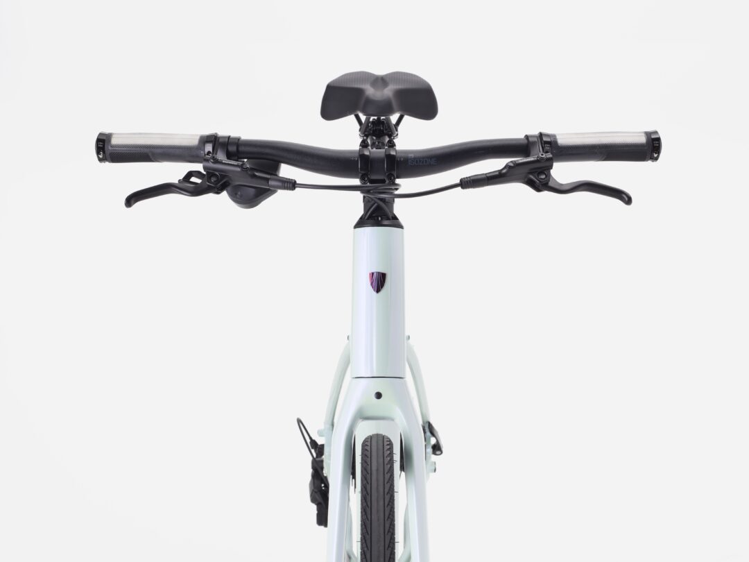 Front view of a bicycle cockpit with handlebars, brake levers, and saddle visible above the stem