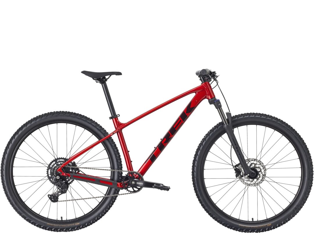 Red mountain bike frame with front suspension, cropping shows part of wheels and drivetrain