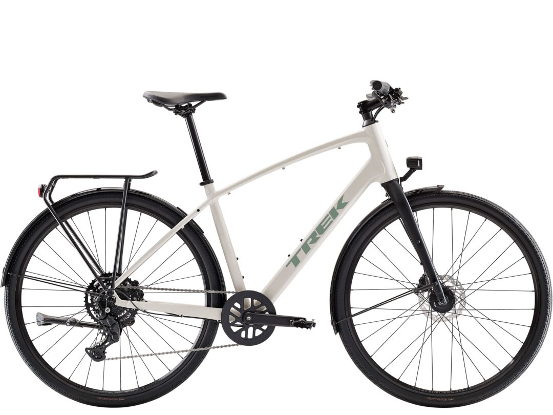 Side view of a beige Trek bicycle showing the frame, wheels, and drivetrain against a white background.