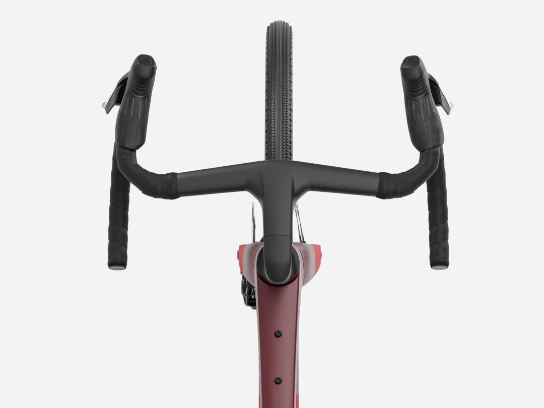 Top-down view of a road bike cockpit, showing drop handlebars, brake levers, and a centered front tire with a burgundy frame visible below.