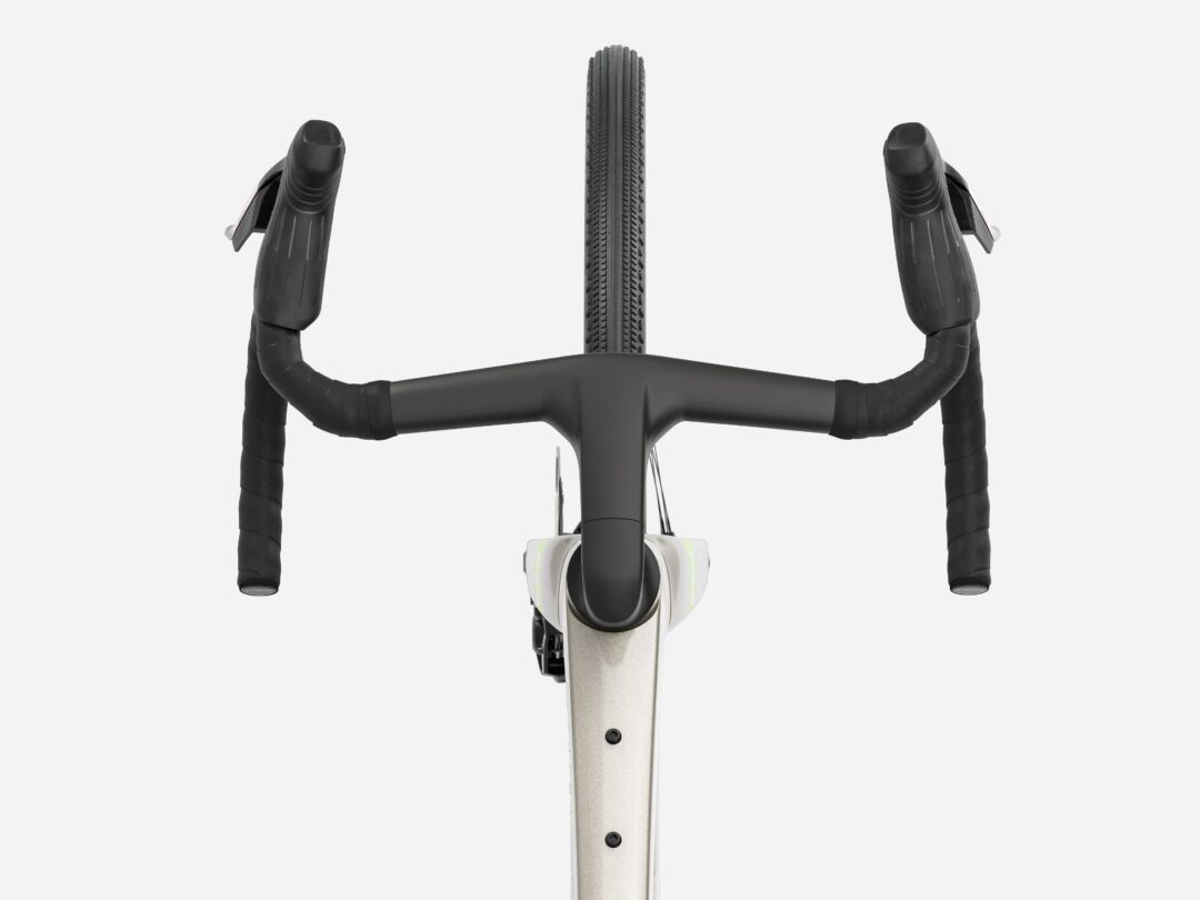Top-down view of a road bike cockpit with drop handlebars, stem, and front tire centered against a light background.
