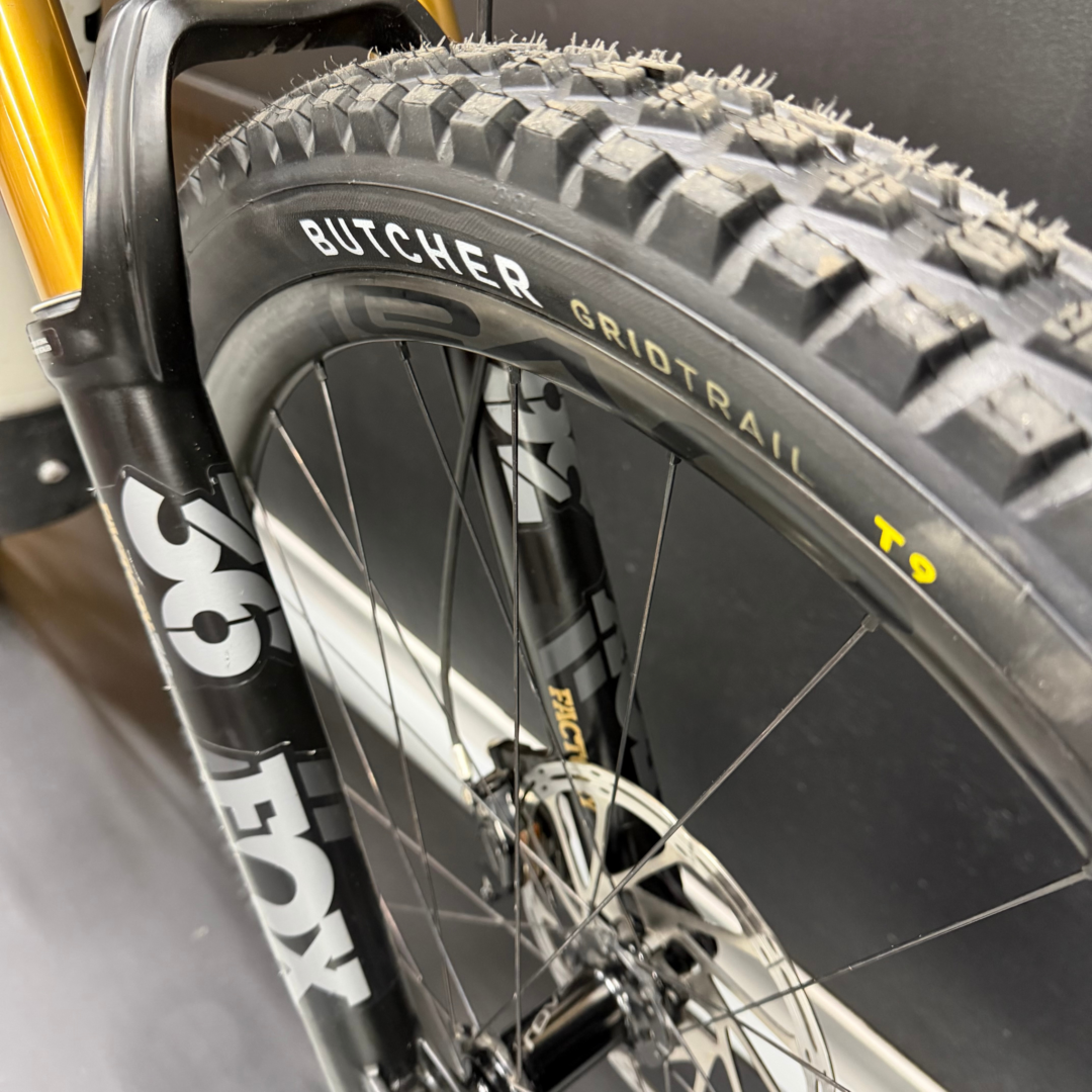Close-up of a mountain bike tire with chunky knobby tread; sidewall shows the model name BUTCHER GRID TRAIL.