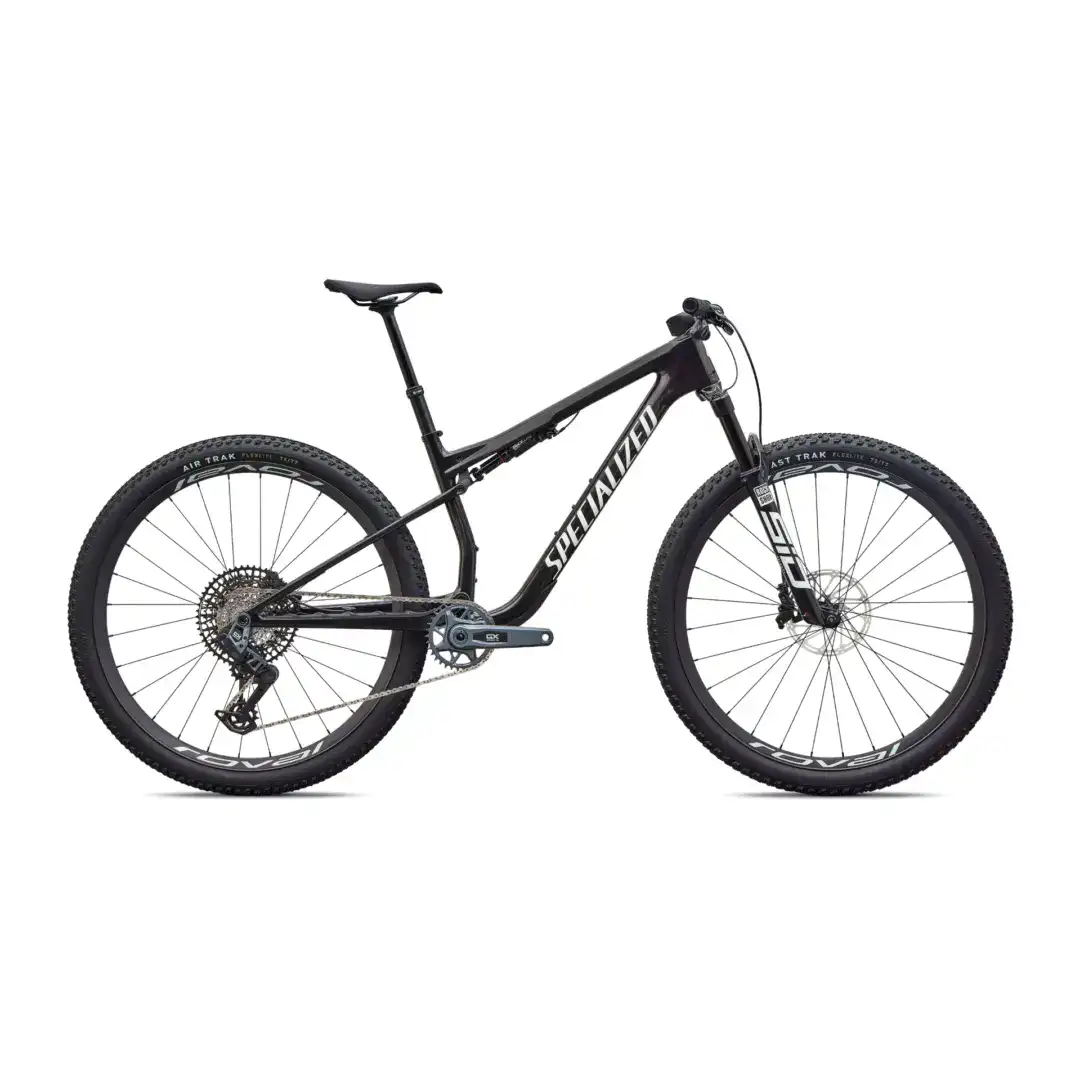 Partially visible black mountain bike with thick knobby tires on a white background, showing the saddle, frame, and handlebars and front wheel.