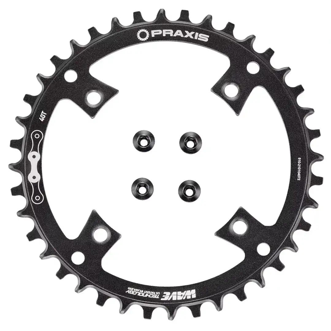 Black Praxis chainring with 40T marking, featuring large cutouts and bolt holes for bike crankset attachment.