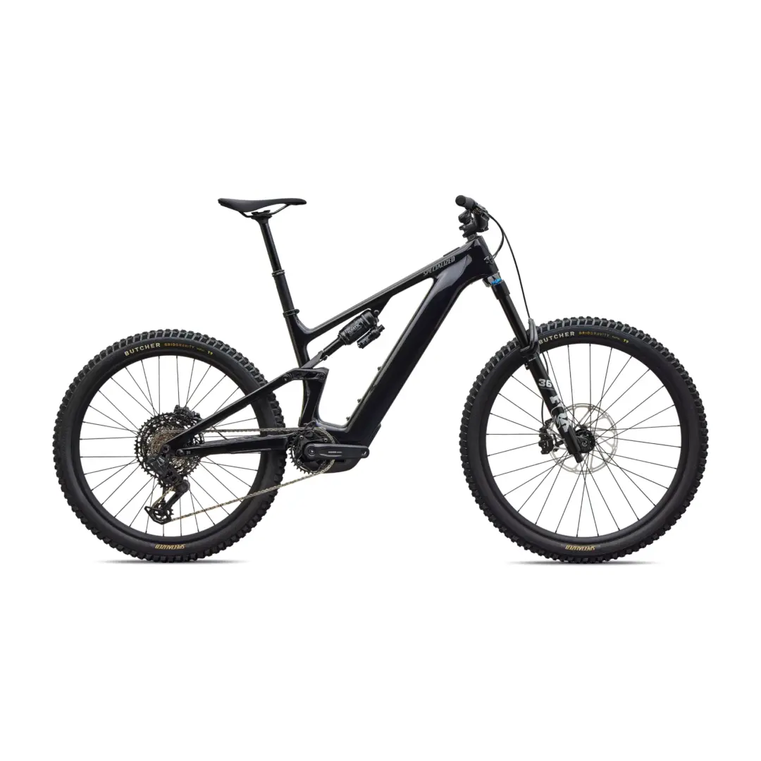 Partial view of a black full-suspension mountain bike showing the frame, front suspension fork, and knobby tires against a white background.