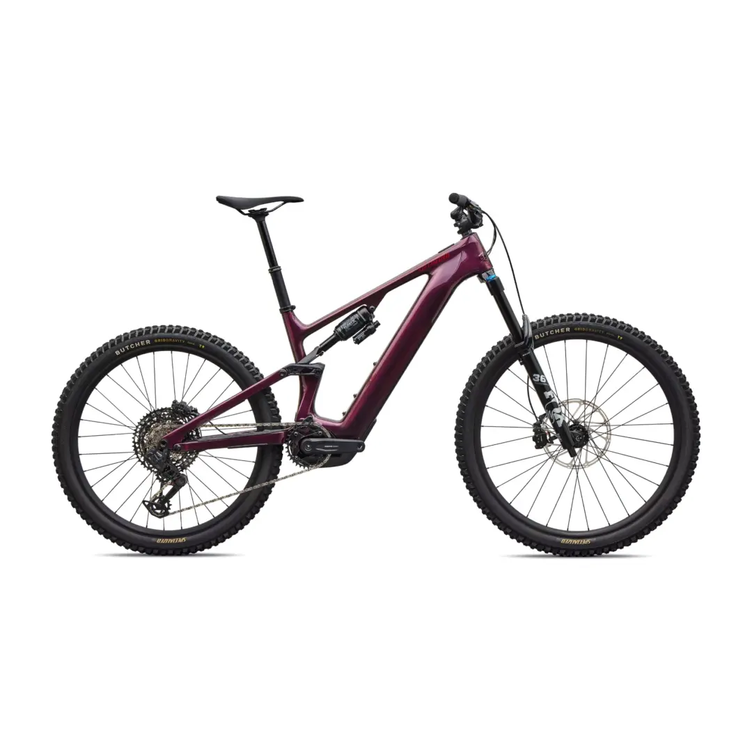 Purple full-suspension mountain bike shown from the side with knobby tires against a white background, frame and components visible