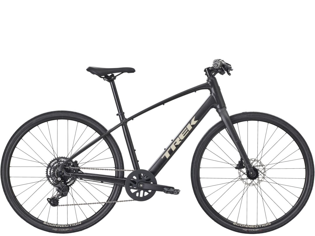Black dual-suspension bicycle frame with front and rear wheels, drivetrain, and handlebars visible (close-up of mid-section).