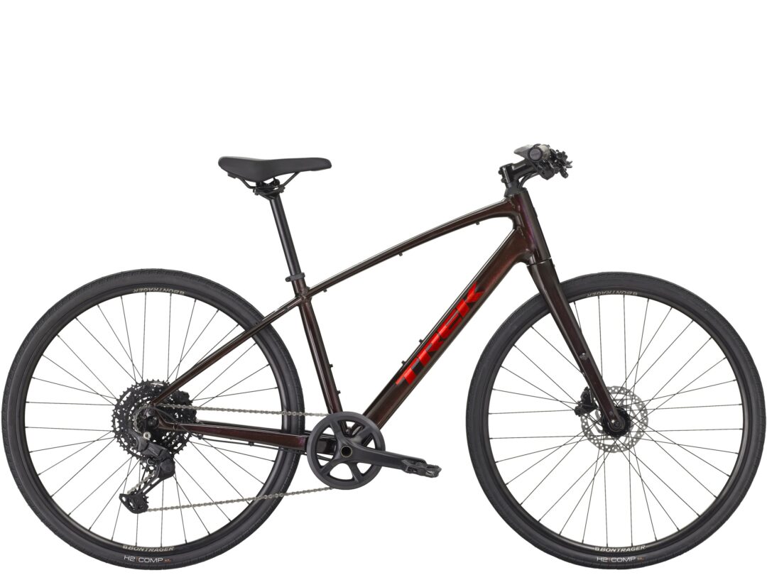 Two-wheeled mountain bike shown from the side, revealing the burgundy frame, crankset, drivetrain, and disc brakes on both wheels.